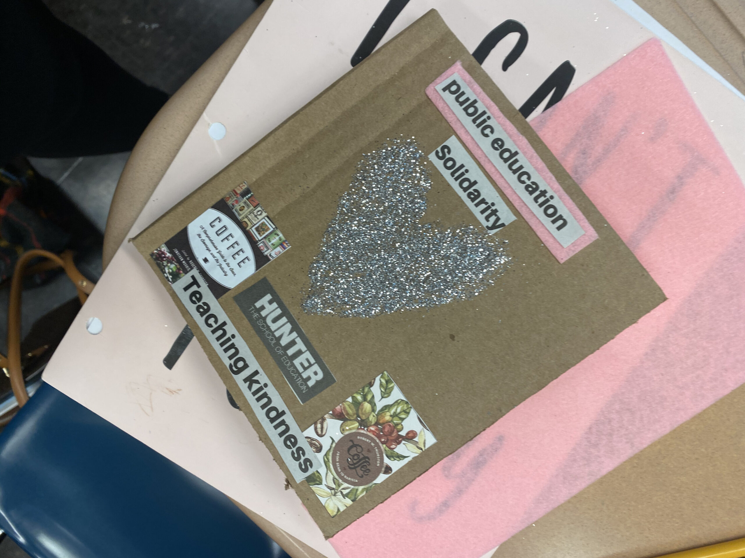a cartonera book cover featuring a silver glitter heart, coffee shop business cards, the Hunter College logo, and the phrases "public education," "solidarity," and "Teaching kindness"