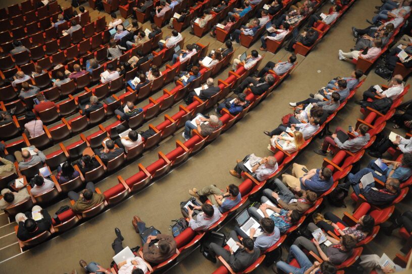 an overhead view of a partly full lecture hall